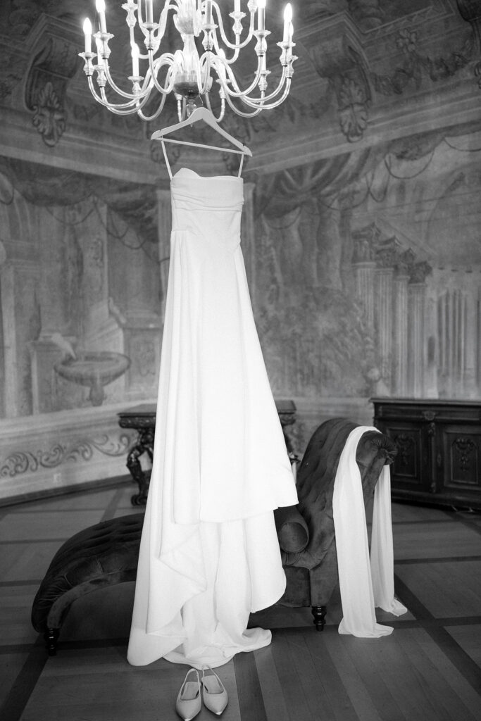 mila nova wedding dress hanging froma chandelier